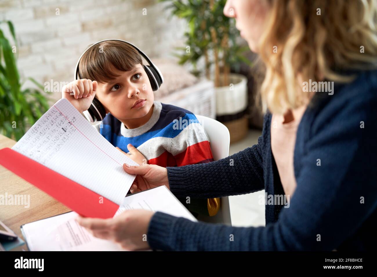 Mother checks her son's math homework Stock Photo