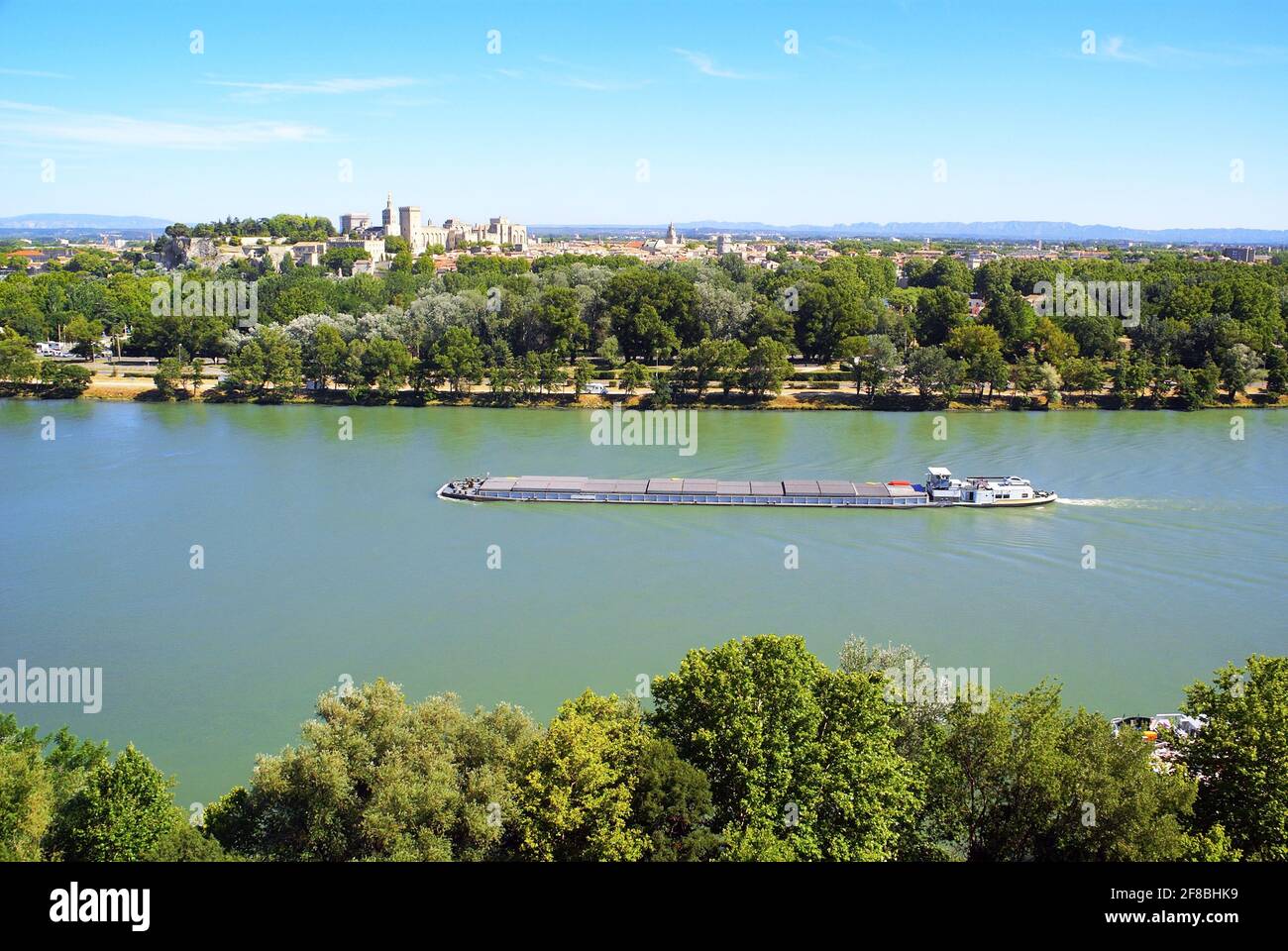 Barge loaded with containers on a big river. Stock Photo