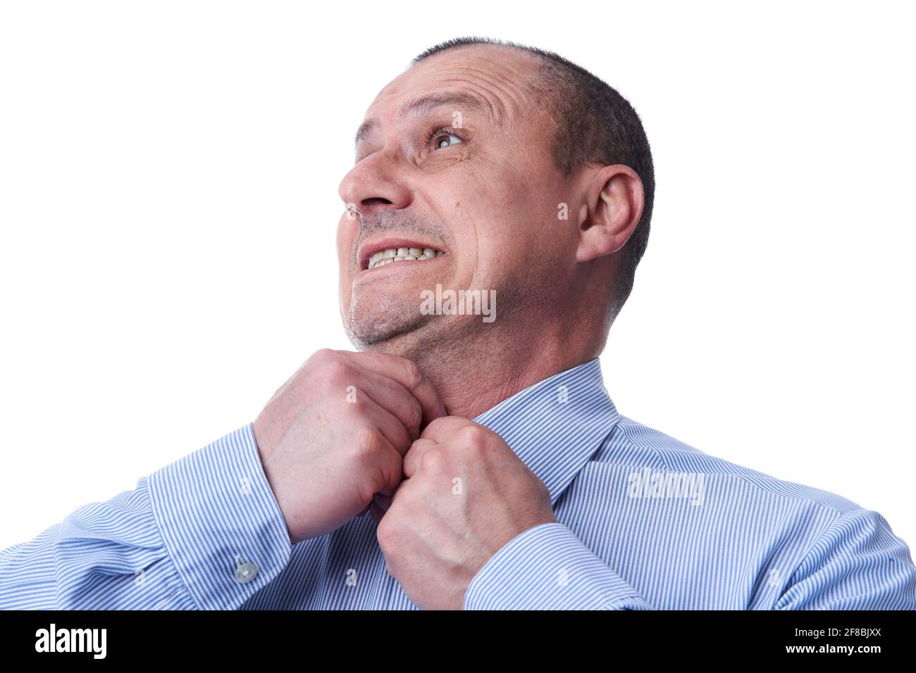 Businessman with a funny face trying to close his last button on the tootight shirt Stock Photo