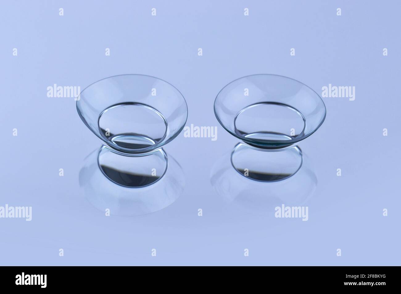 Contact lenses on blue background Stock Photo