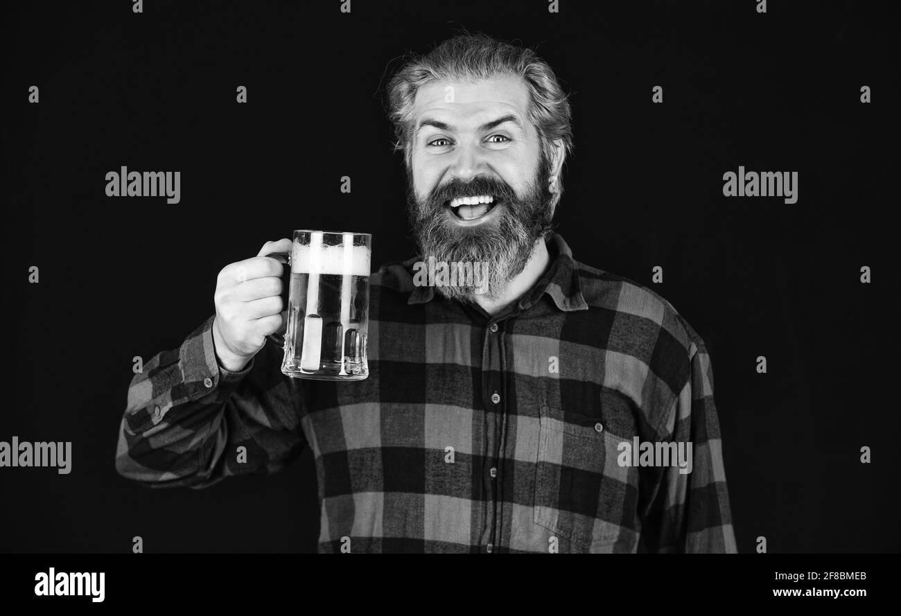 Controlling beer quality. Brutal bearded male drinks beer from glass. Beer pub. bartender or barman in bar. recreation. Man hold glass of beer Stock Photo