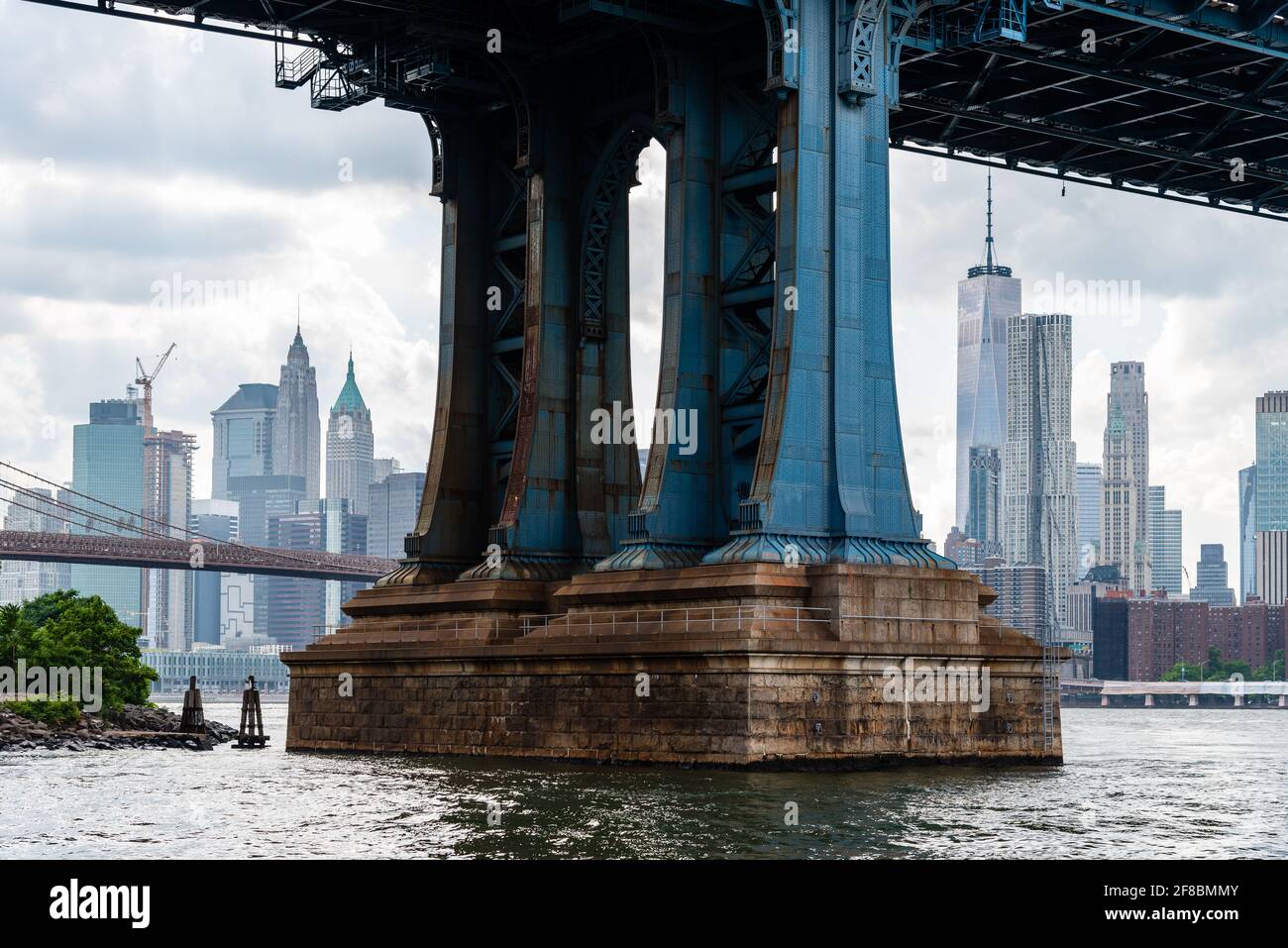 Detail of Pillar of Manhattan Bridge against cityscape of New York City. Steel Abutment With