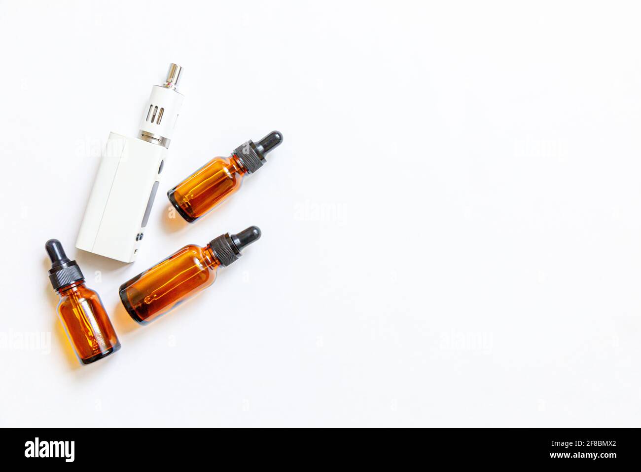 Vaping device e-cigarette electronic cigarette and liquid bottles isolated on white background. Vape device for alternative smoking. Vaping shop conce Stock Photo