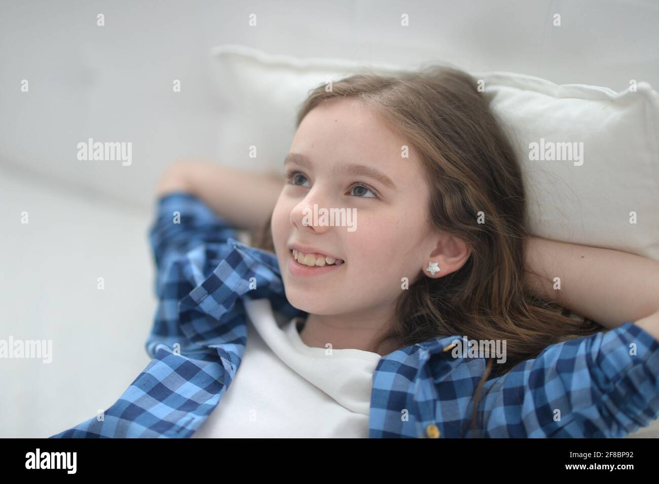 Cute little girl lying in bed at home Stock Photo - Alamy