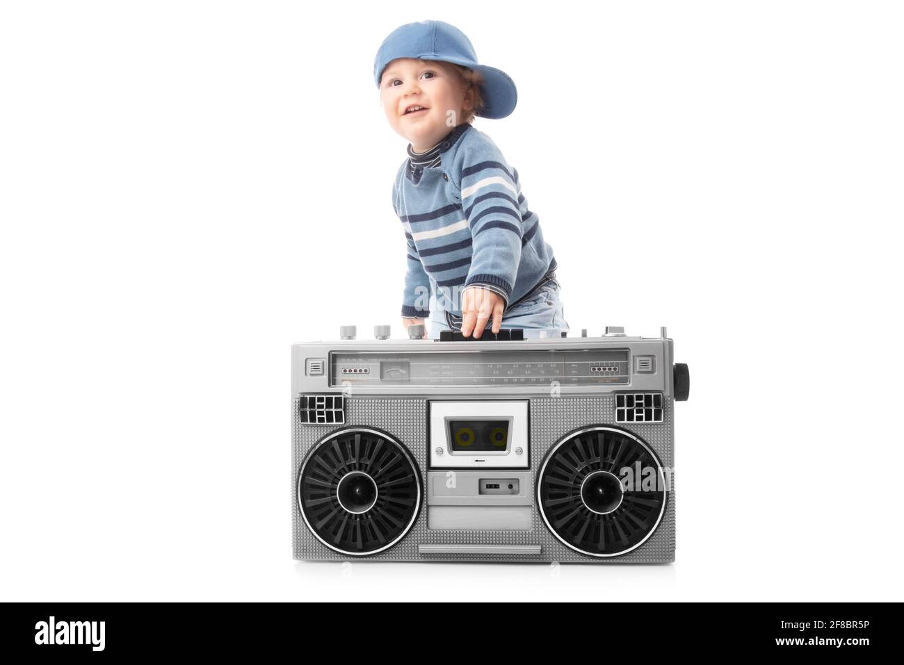 Baby boy enjoying retro boombox radio and hip hop style Stock Photo