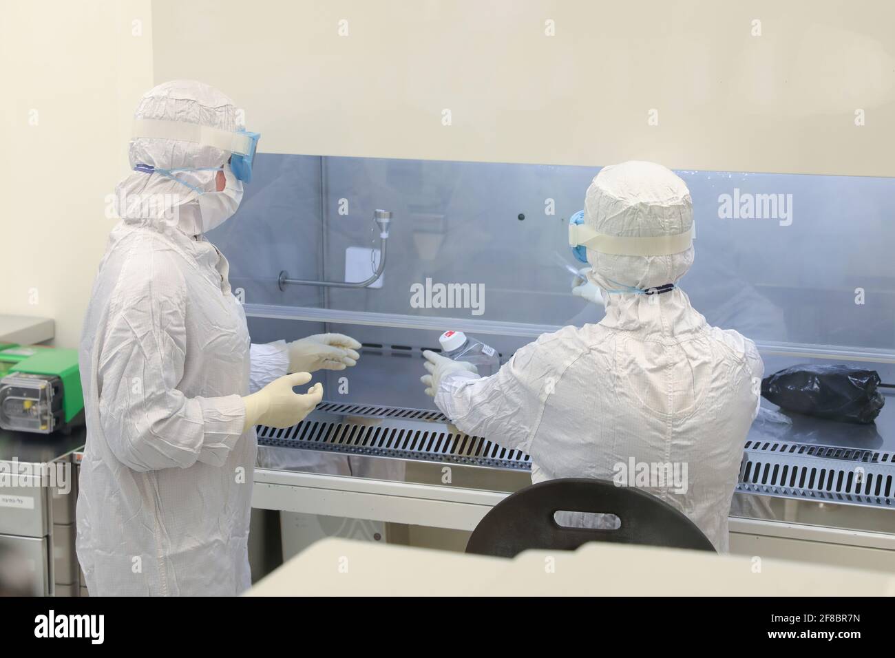 Lab scientists wear protective clothing and doing medical research in a