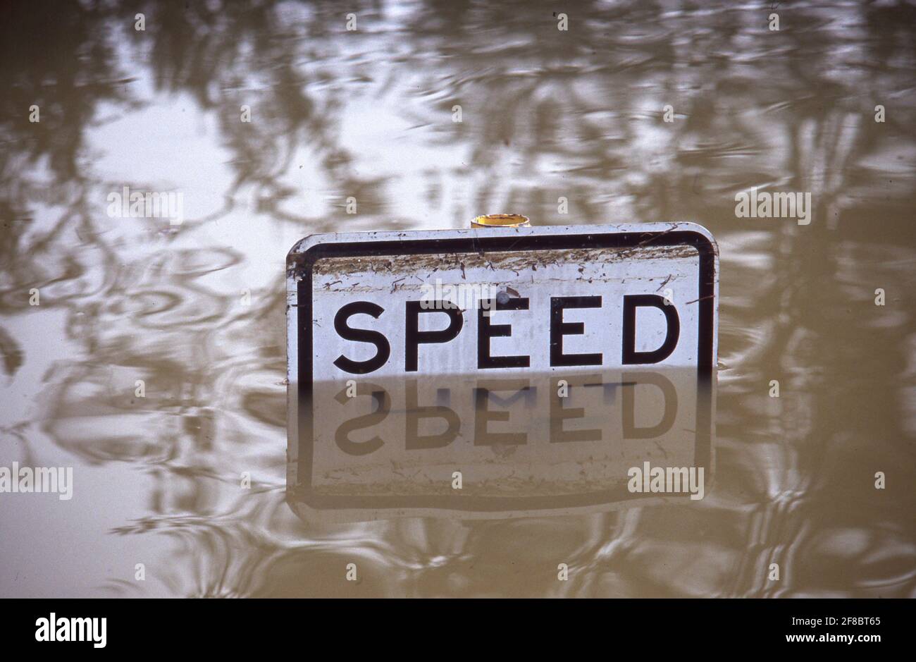 A speed limit sign peeks out above rising waters during flooding on Lake Travis near Austin, Texas in the Graveyard Point neighborhood, one of the lowest developed spots on the lake. ©Bob Daemmrich Stock Photo