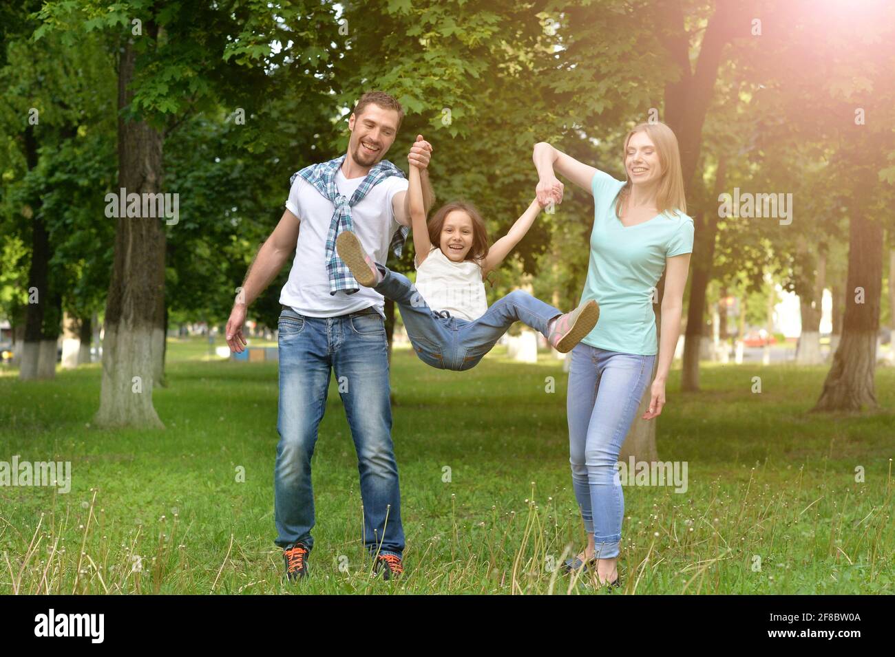 Happy family with their little daughter in the park Stock Photo