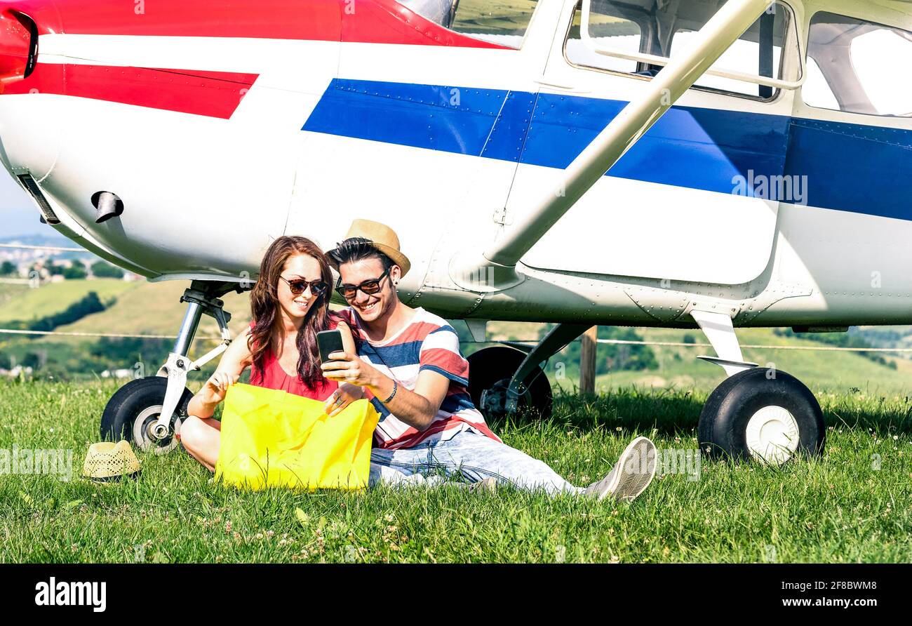 Young couple of lovers having a rest during charter airplane excursion - Wanderlust concept of alternative people lifestyle traveling around the world Stock Photo