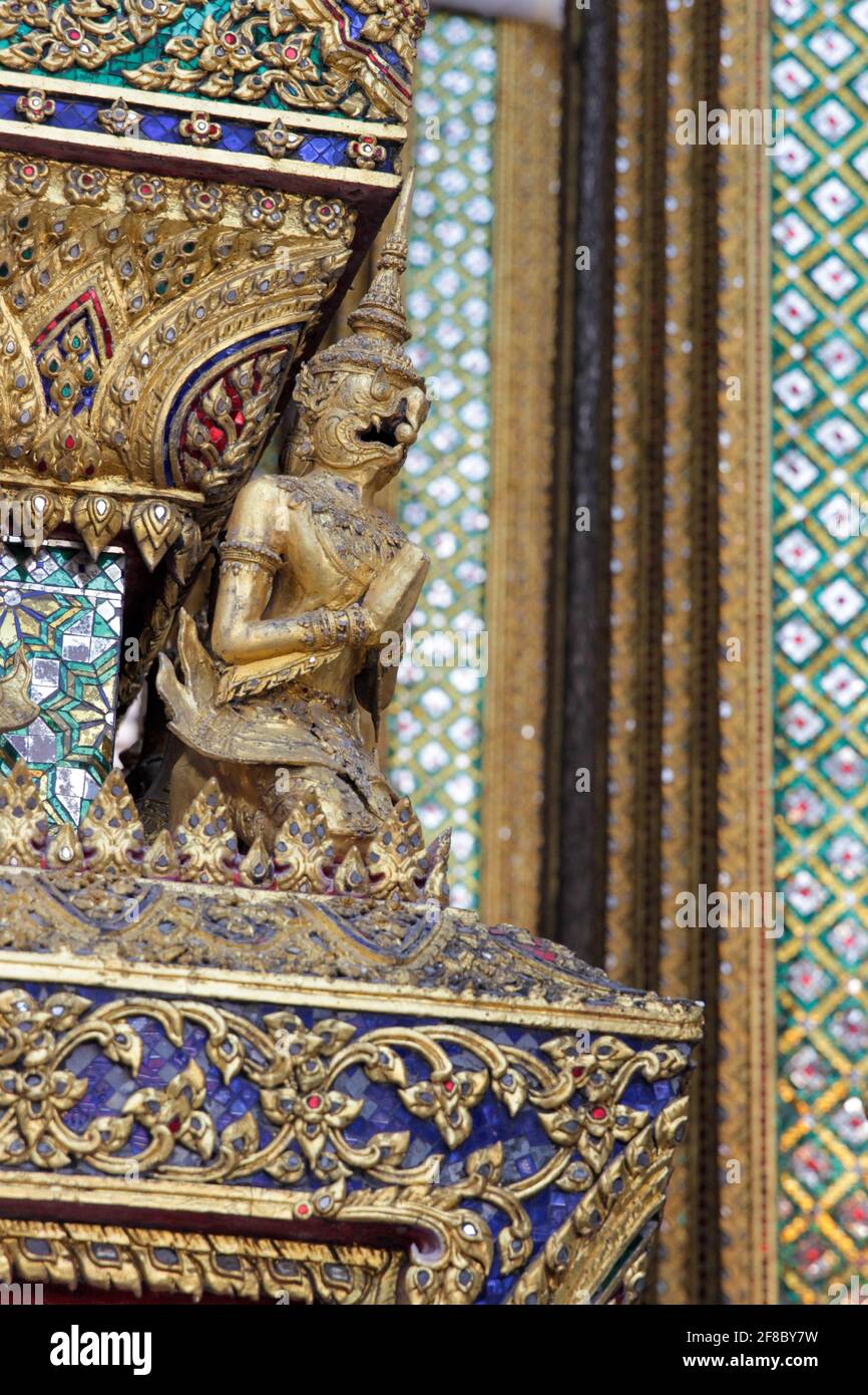 Close up detail of traditional carved gold figure on Thai temple in Bangkok Thailand Stock Photo
