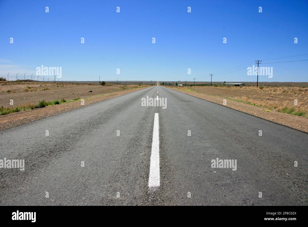 Hitchhiking along empty highway with no people in Keetmanshoop, Namibia. Stock Photo