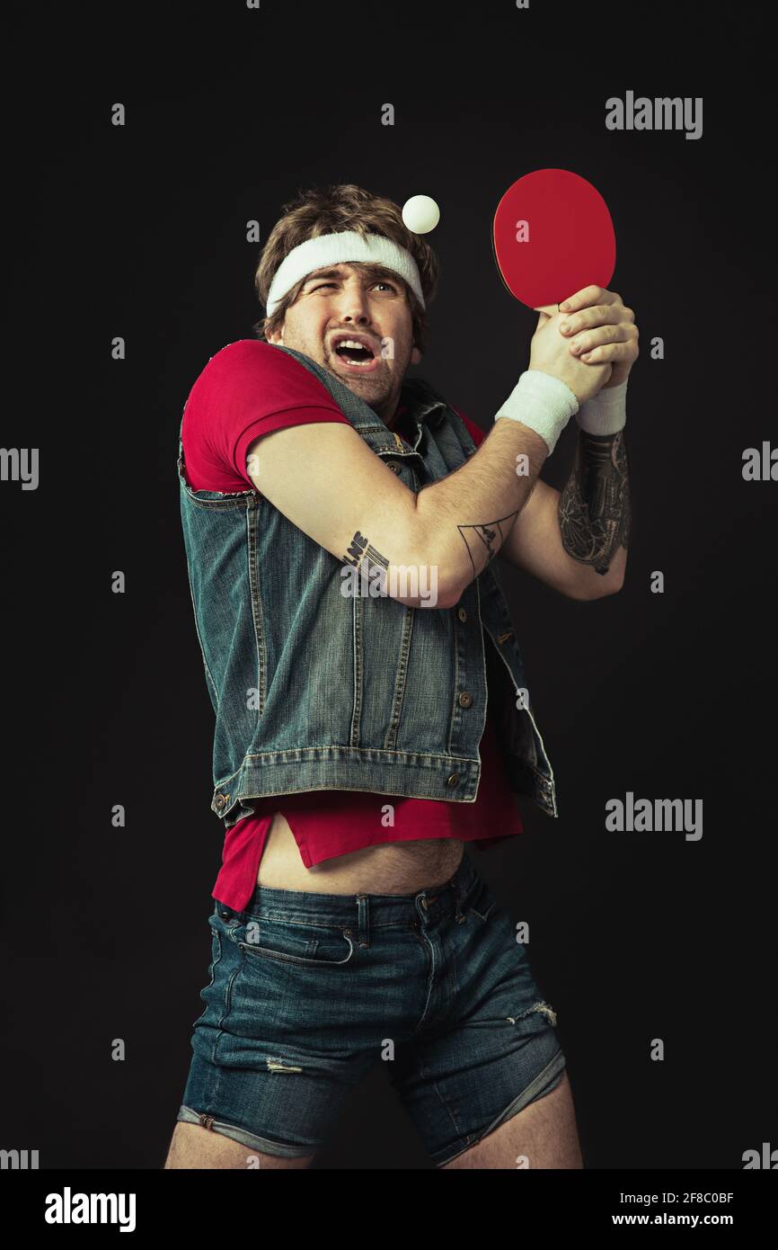 Young Caucasian funny man playing ping pong isolated on black background  Stock Photo - Alamy