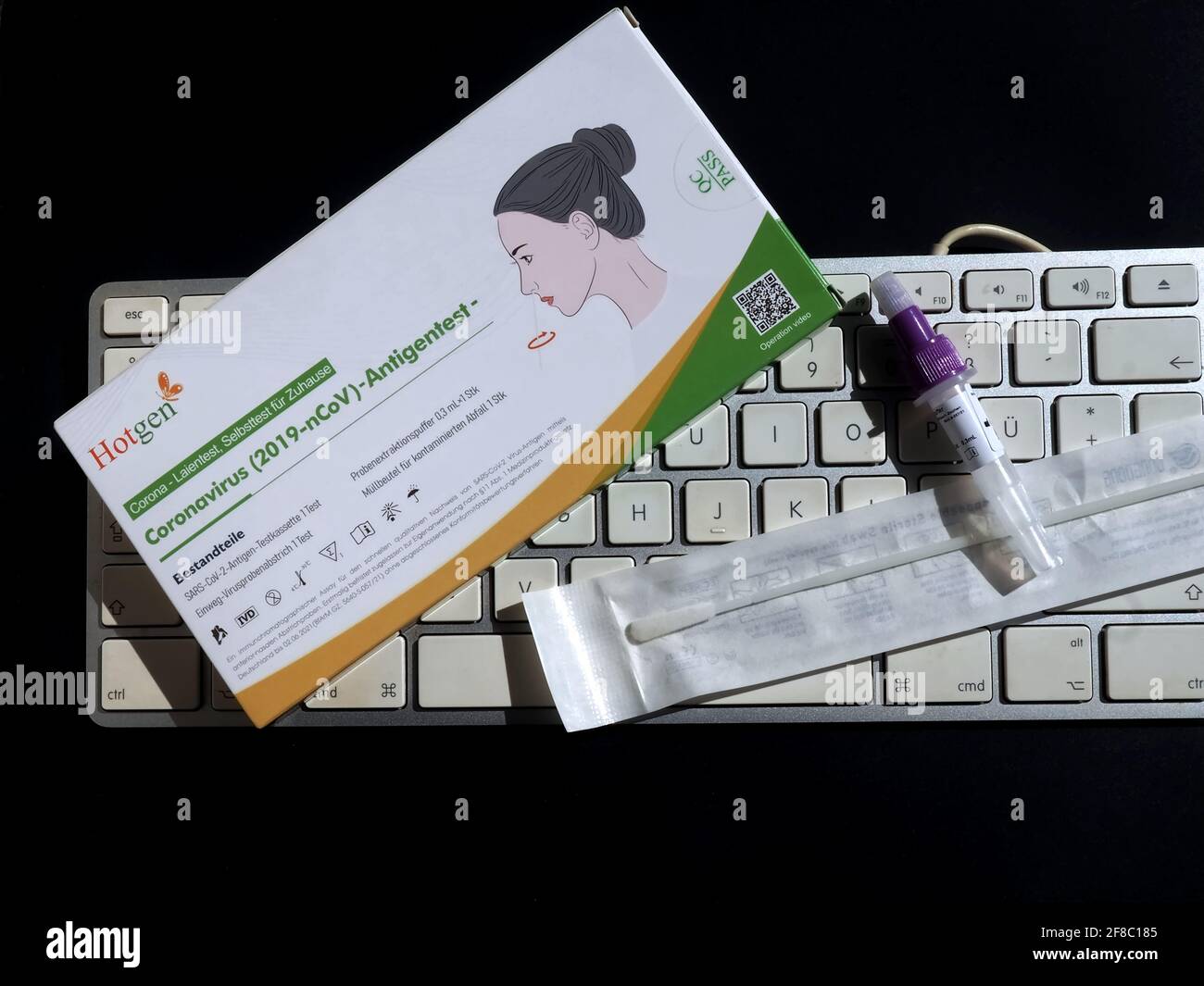 German hotgen Corona or Covid-19 home testing kit with a keyboard Stock Photo