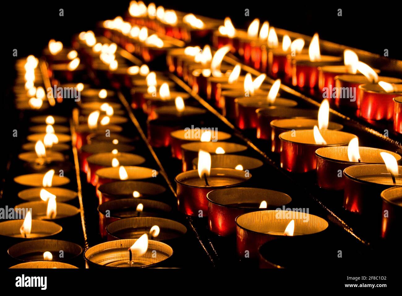 Shelf of lit candle offerings in a charuch Stock Photo Alamy