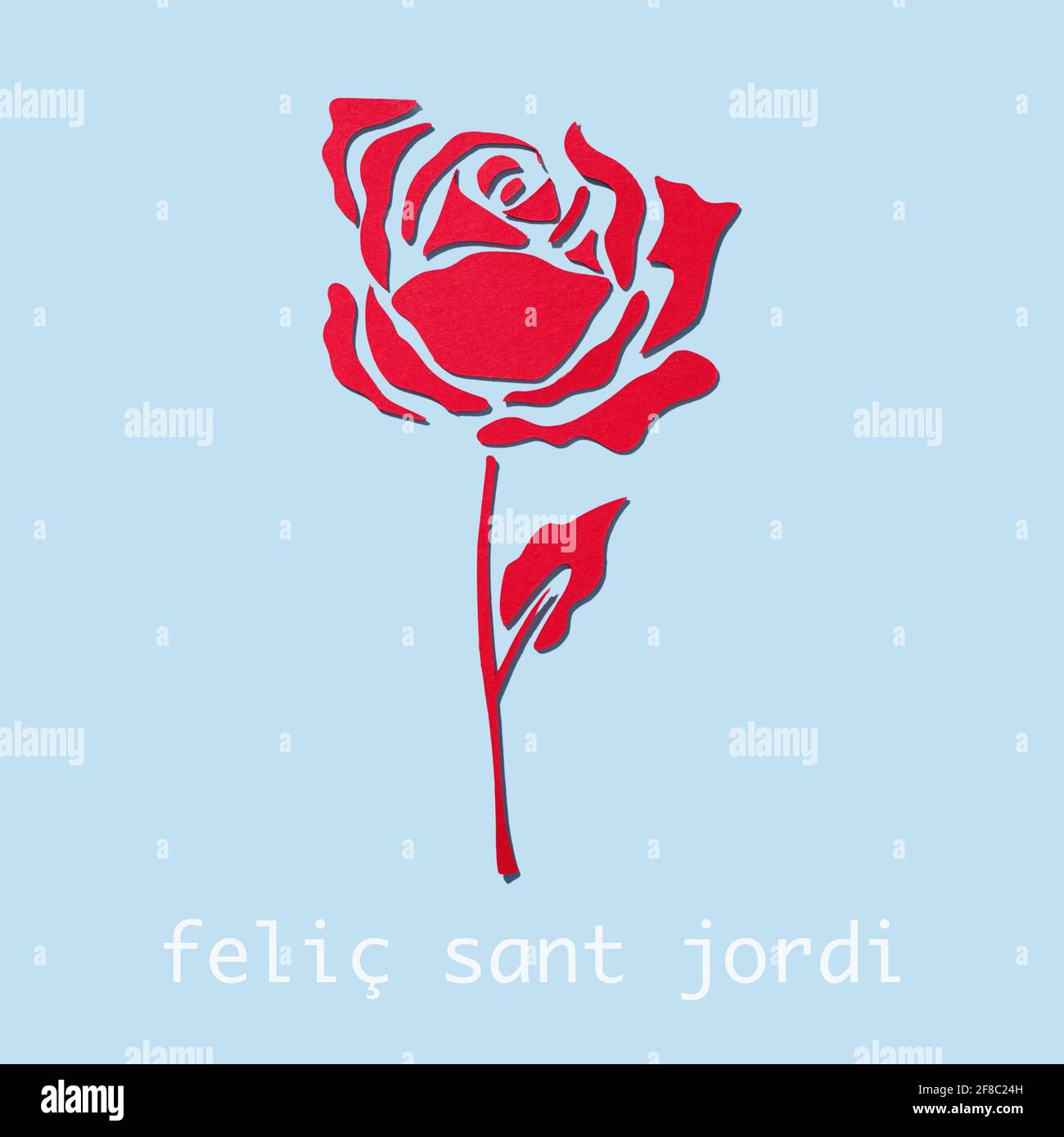 a rose, made with cutouts of a red paper, on a blue background and the ...
