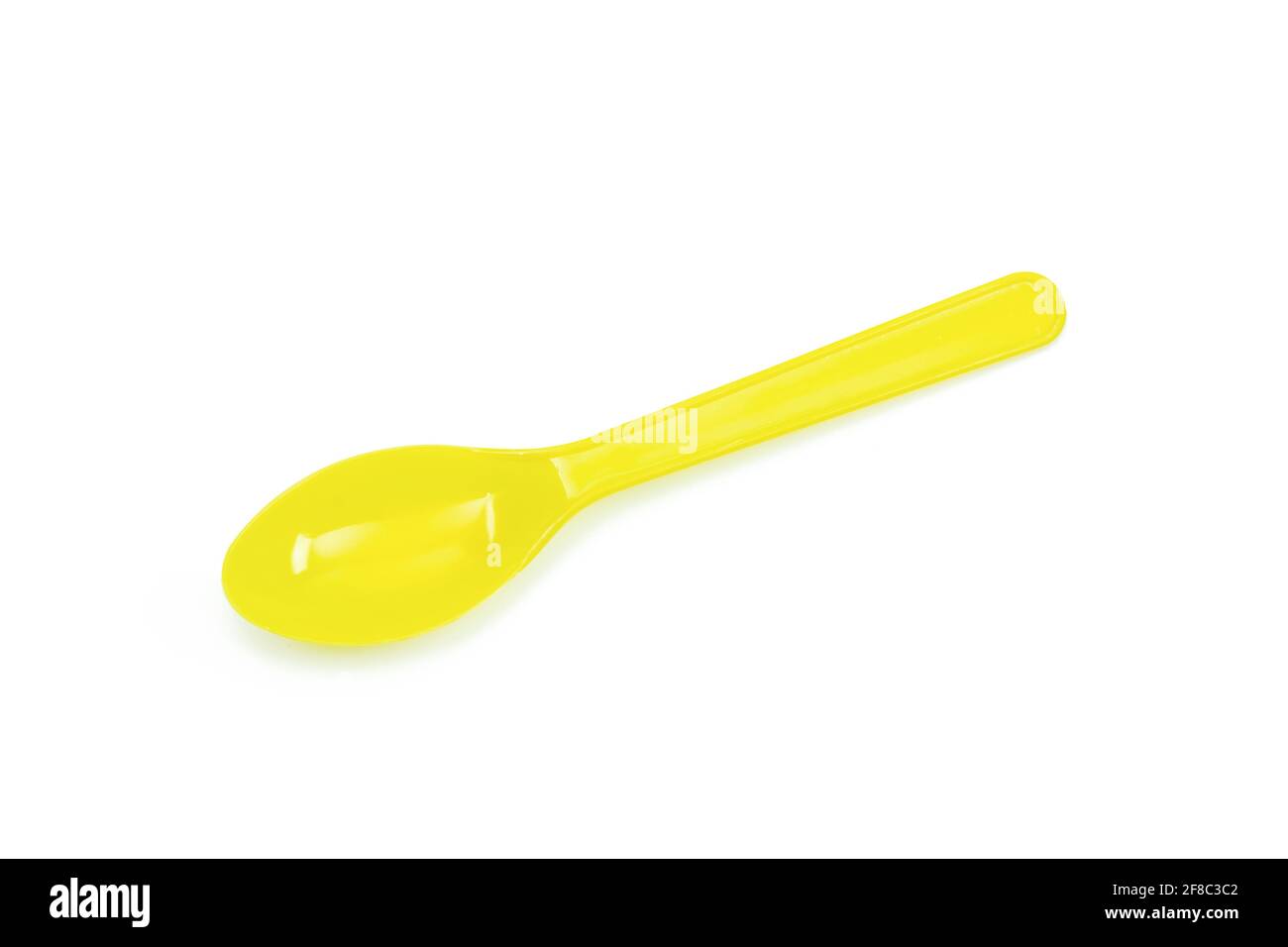 Yellow plastic spoon isolated on white background Stock Photo
