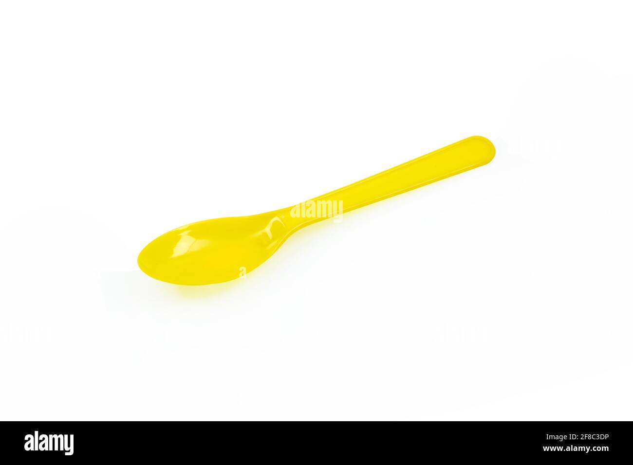 Yellow plastic spoon isolated on white background Stock Photo