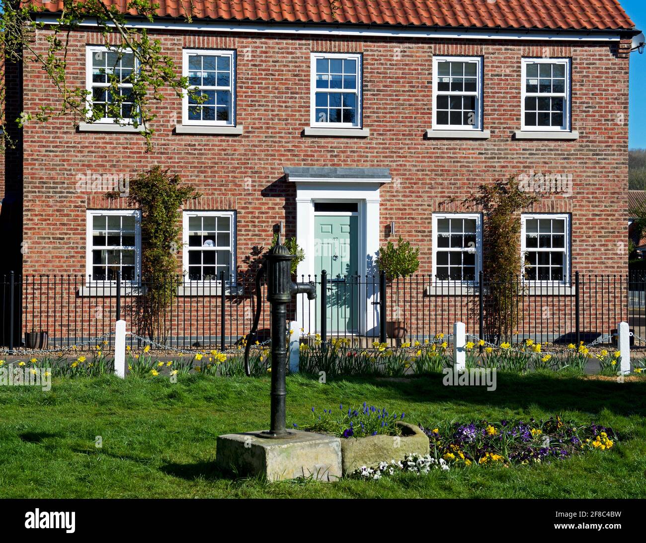 House, and old water pump on village green, in Elloughton, East