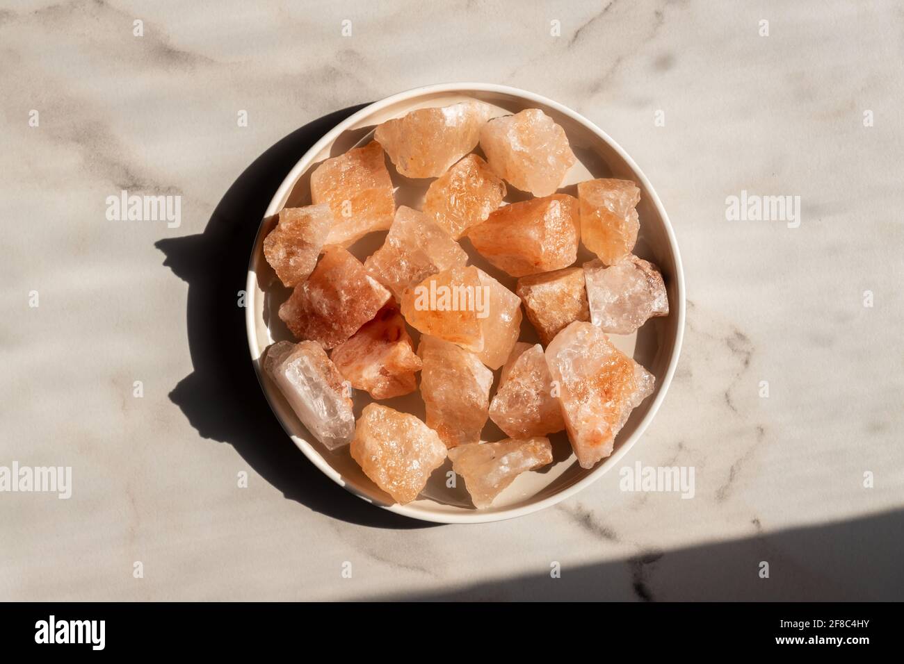 Organic Himalayan mineral salt crystals on round ceramic tray