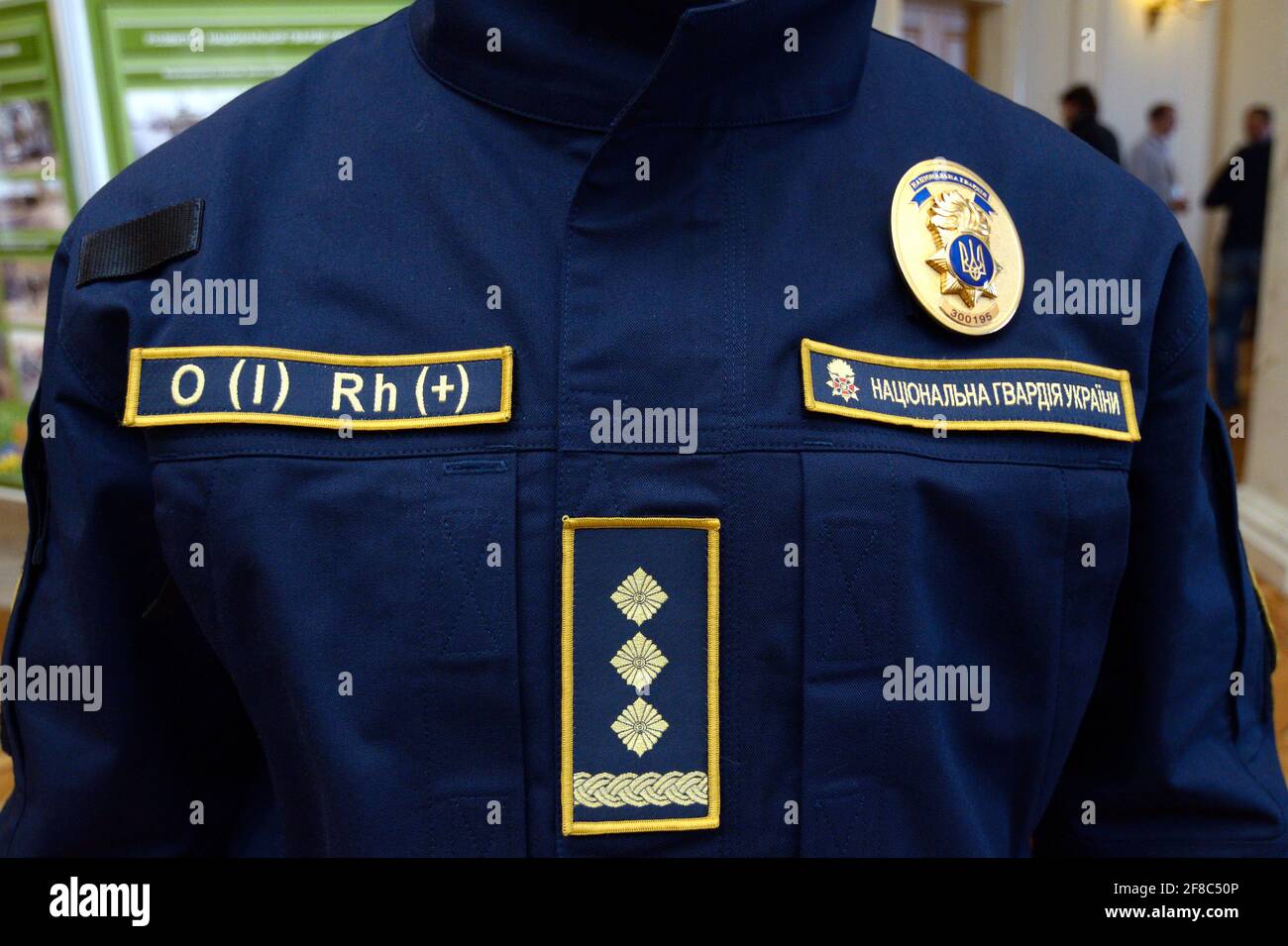 Upper part of Ukrainian police uniform, cold-climate clothing: coat, chevron, police badge, patch with blood type. October 7, 2018. Kiev, Ukraine Stock Photo