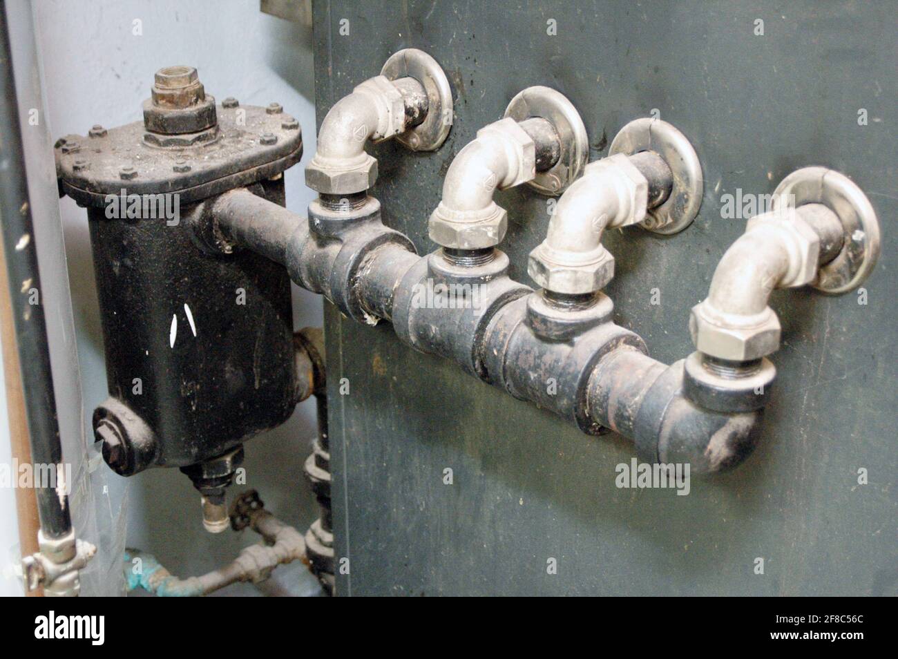 Old house boiler heat exchanger (pipes) Stock Photo