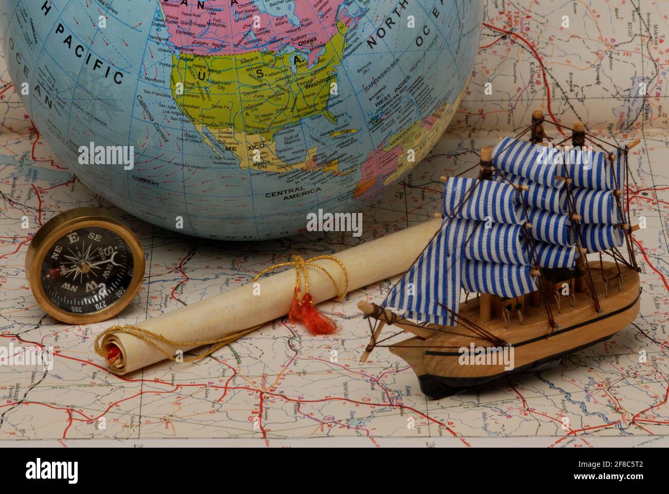 Mumbai, Maharashtra, India, Asia, Sep. 05, 2006 - Old pirate sailboat; ship model; Compass; Globe on old mapTravel, adventure concept Stock Photo