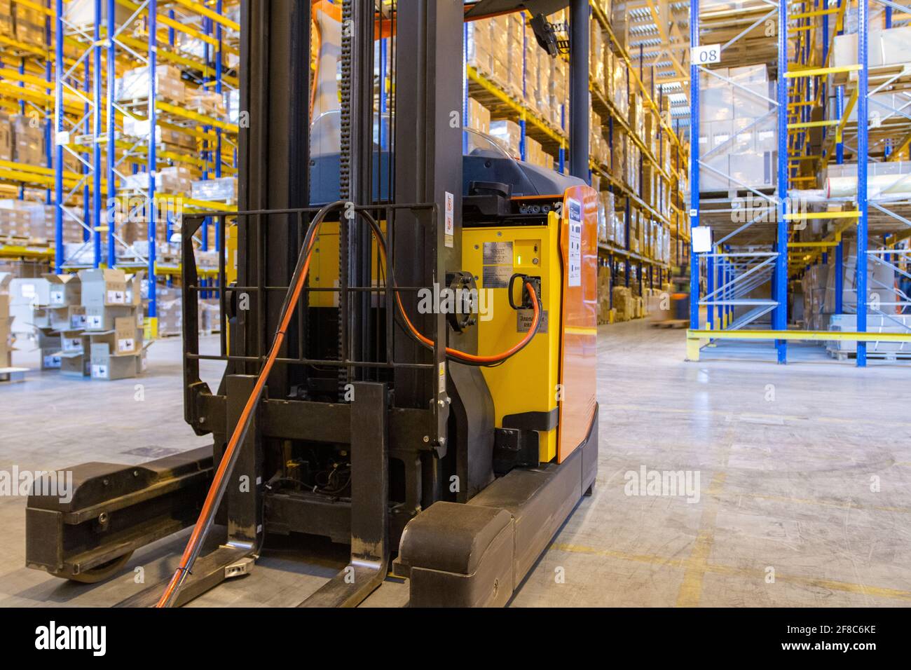 Electrical forklift loader charging in the warehouse. Pallet stacker ...
