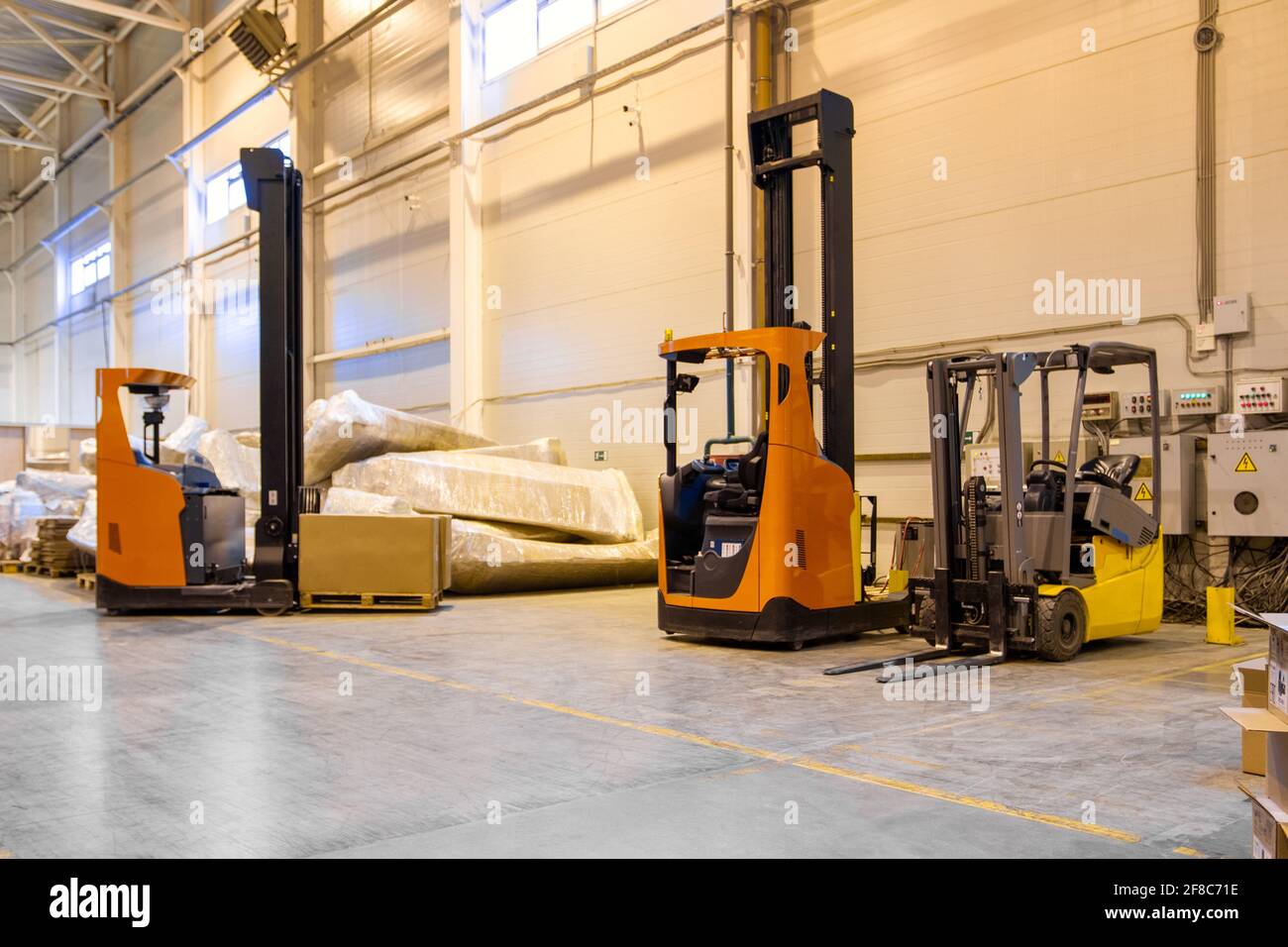 Forklift loader parking at logistics warehouse. Pallet stacker truck equipment inside of a