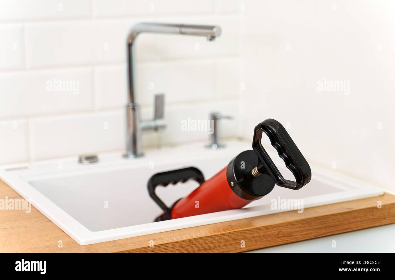 Professional force pump cleaner in the kitchen sink. Stock Photo