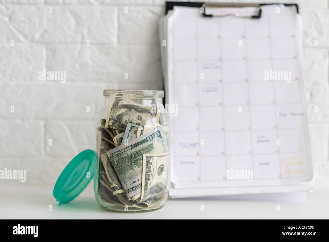 Glass jar full of the American banknotes Stock Photo - Alamy