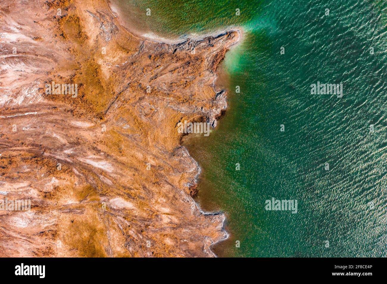 Aerial view about rocky seashore with turquoise waving water. Stock Photo