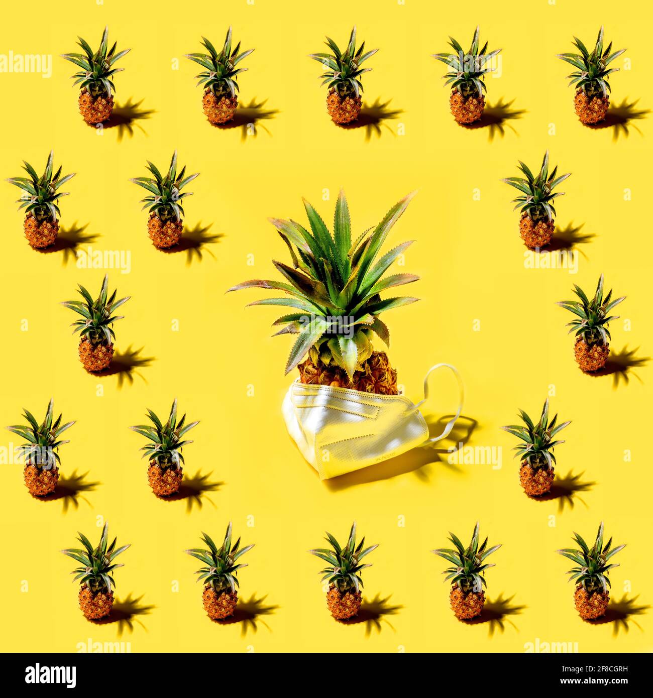 Many pineapples on a solid yellow background pattern Stock Photo
