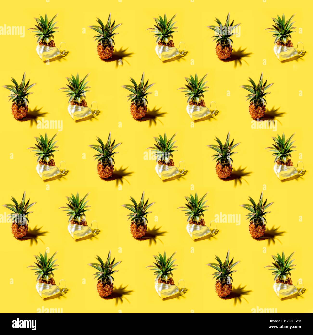 Many pineapples on a solid yellow background pattern Stock Photo