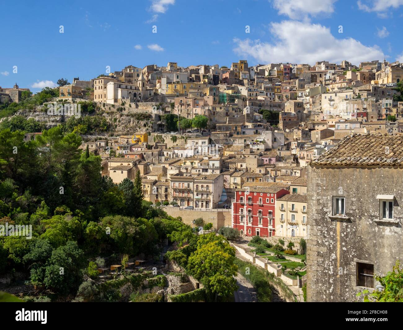 Ragusa buildings rolling down hill over Valle dei Ponti seen from Ibla Stock Photo