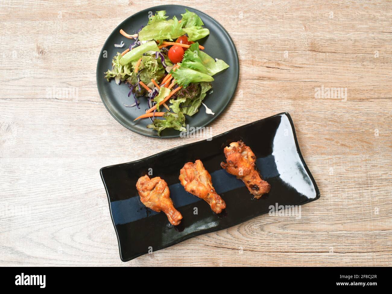 crispy fried chicken drum wing with barbecue sauce and vegetable on