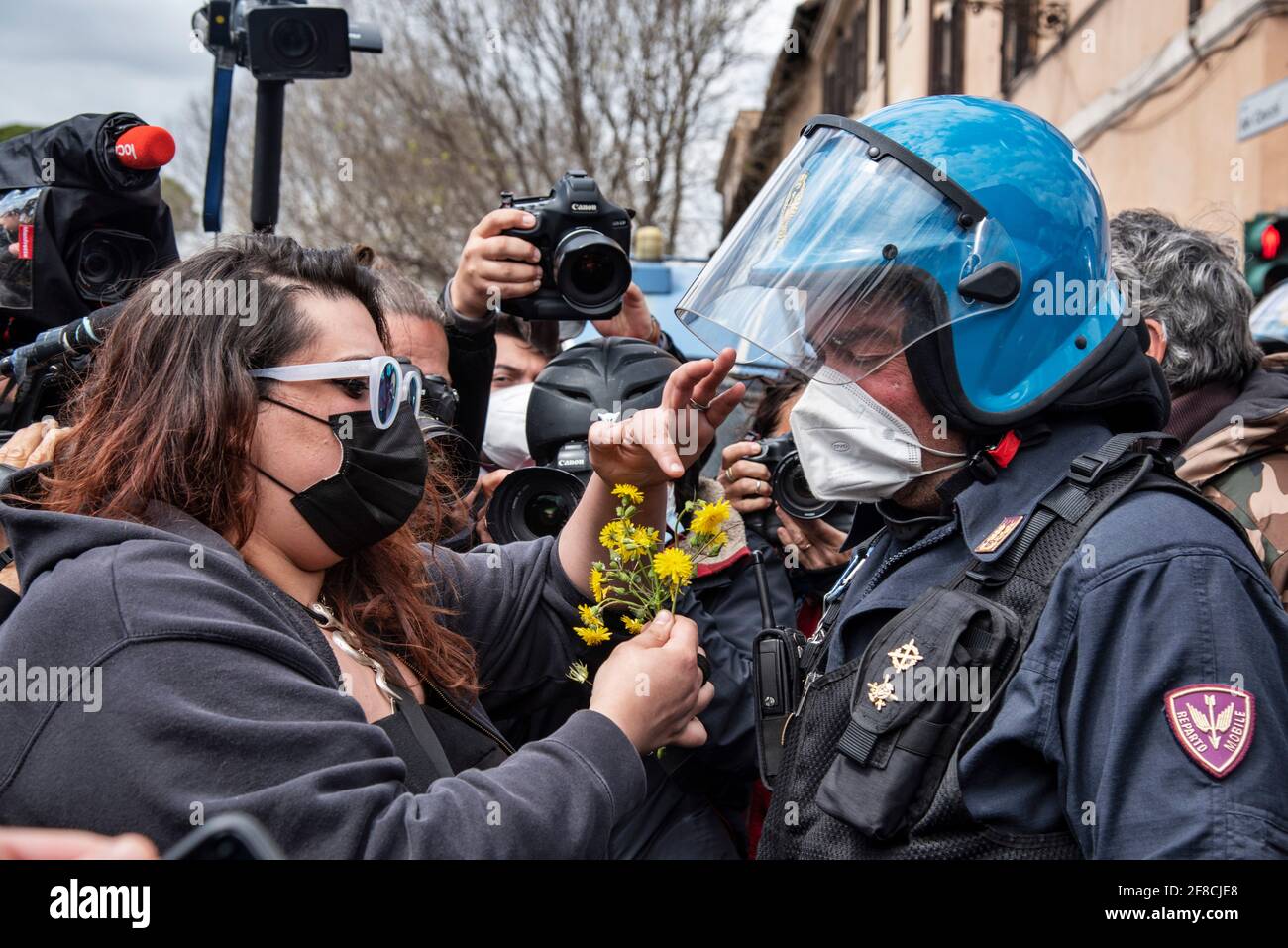 Rome, Italy. 13th Apr 2021. Protesters confront with anti-riot police officers during a demonstration of restaurant owners and workers, entrepreneurs and small businesses owners on April 13, 2021 at Circo Massimo in Rome, Italy. Hundreds of demonstrators gathered at Circo Massimo demanding for the restart of activities forced to stop due to the Covid-19 restrictions. Credit: LSF Photo/Alamy Live News Stock Photo
