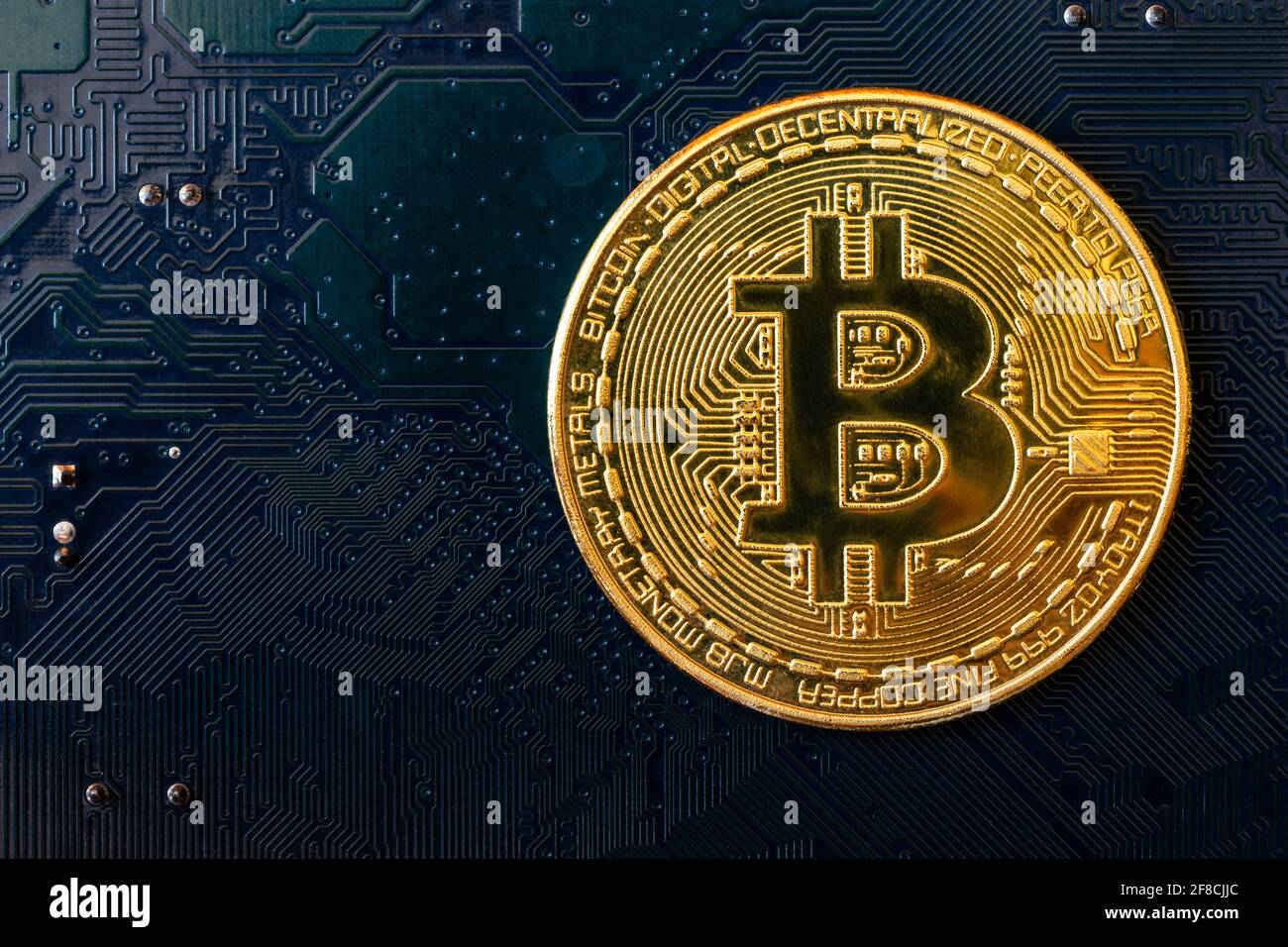 Golden coins with bitcoin symbol on blue mainboard circuit background. Cryptocurrency, Money coin digital. Blockchain technology, bitcoin mining. Stock Photo