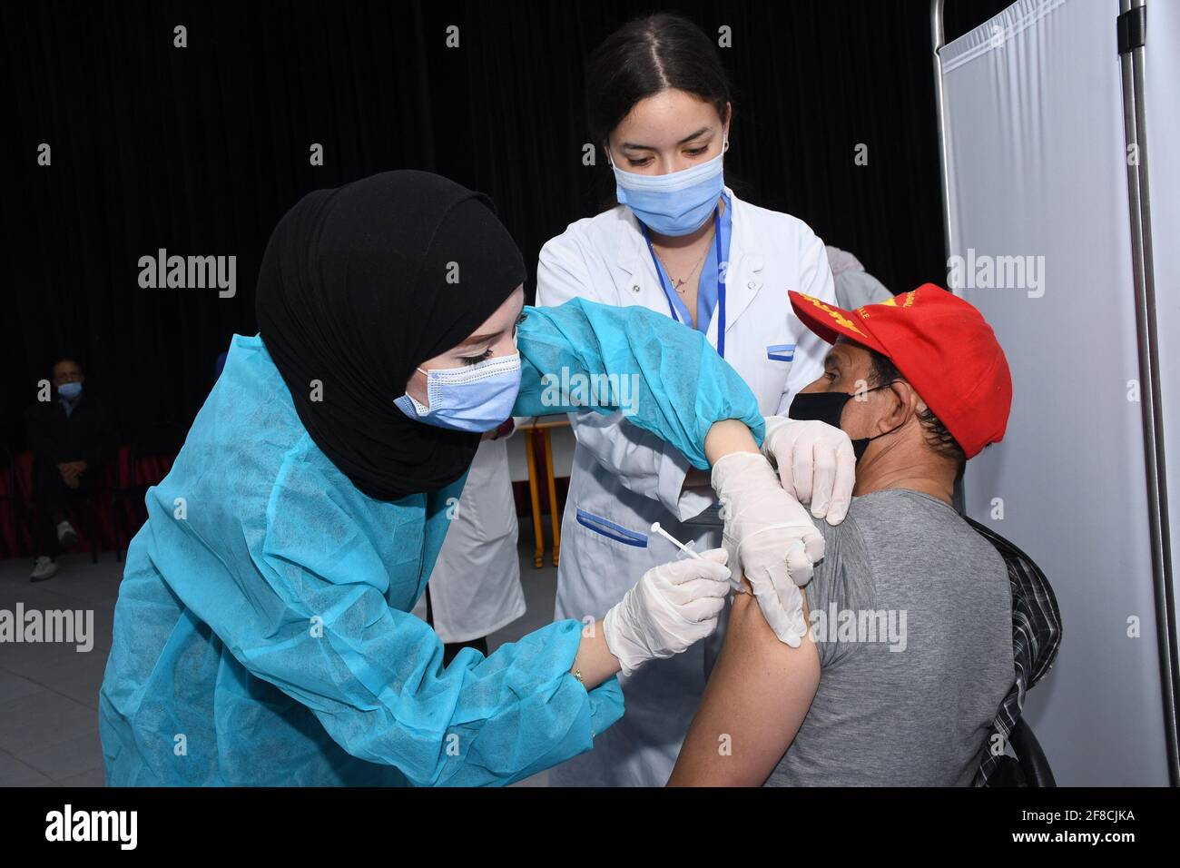 (210413) -- MOHAMMEDIA, April 13, 2021 (Xinhua) -- A medical worker administers a dose of China's Sinopharm COVID-19 vaccine to a resident in Mohammedia, Morocco, on April 13, 2021. Morocco's COVID-19 tally rose to 502,277 on Monday as 175 new cases were registered during the past 24 hours. (Photo by Chadi/Xinhua) Stock Photo