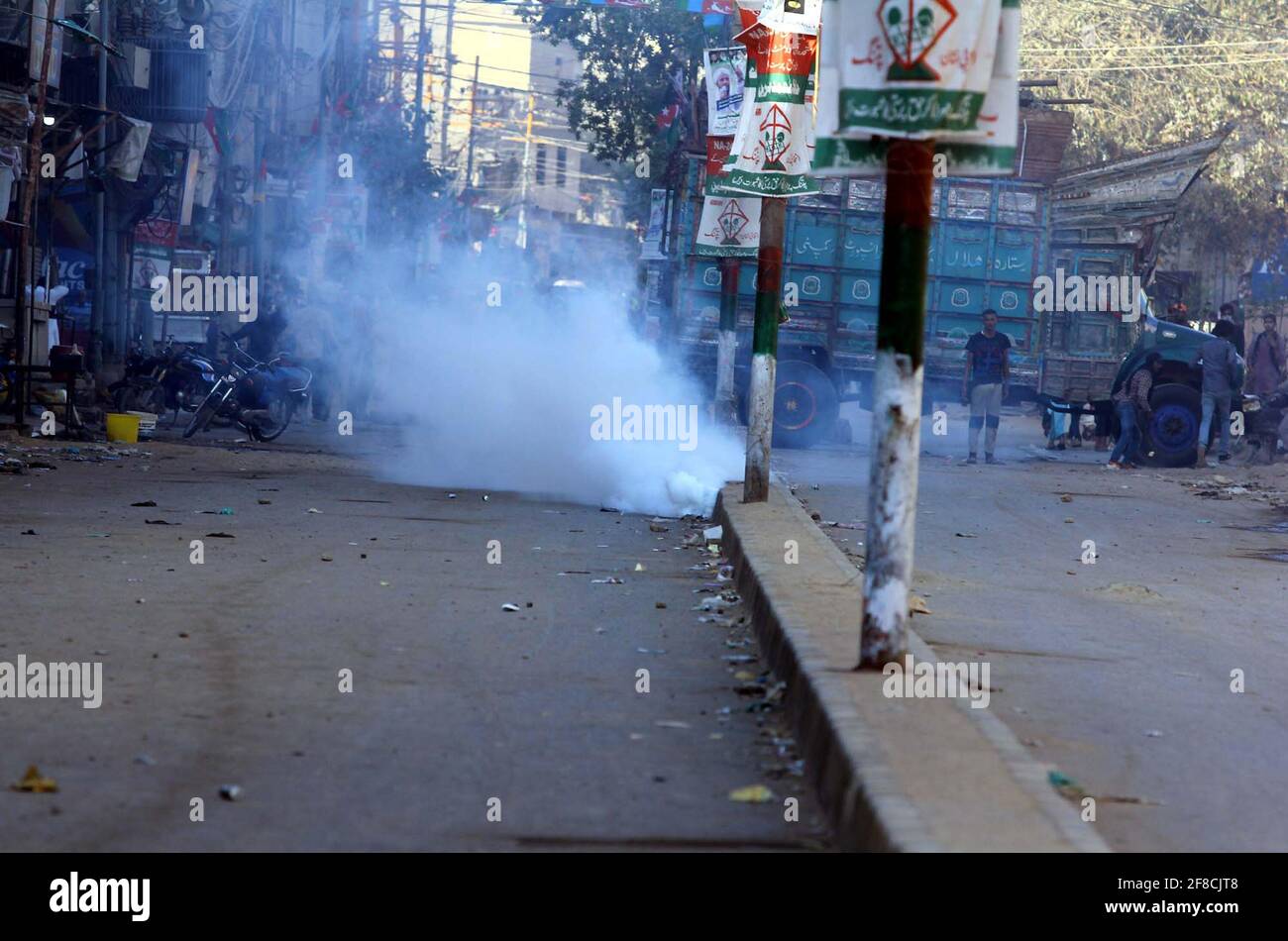 Police officials restore baton charge and fired tear gas shells to repel protesters during protest demonstration of Tehreek-e-Labbaik (TLP) against arrested of Saad Hussain Rizvi, Chief of Tehreek-e-Labbaik Pakistan (TLP) son of late cleric Khadim Hussain Rizvi, Baldia Town in Karachi on Tuesday, April 13, 2021. Stock Photo