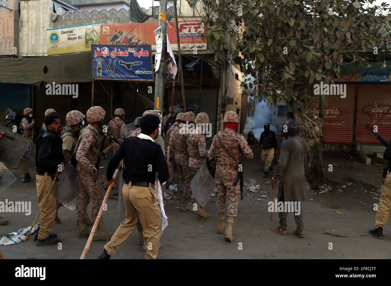Police officials restore baton charge and fired tear gas shells to repel protesters during protest demonstration of Tehreek-e-Labbaik (TLP) against arrested of Saad Hussain Rizvi, Chief of Tehreek-e-Labbaik Pakistan (TLP) son of late cleric Khadim Hussain Rizvi, at Baldia Town in Karachi on Tuesday, April 13, 2021. Stock Photo