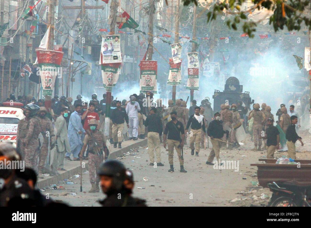 Police officials restore baton charge and fired tear gas shells to repel protesters during protest demonstration of Tehreek-e-Labbaik (TLP) against arrested of Saad Hussain Rizvi, Chief of Tehreek-e-Labbaik Pakistan (TLP) son of late cleric Khadim Hussain Rizvi, at Baldia Town in Karachi on Tuesday, April 13, 2021. Stock Photo