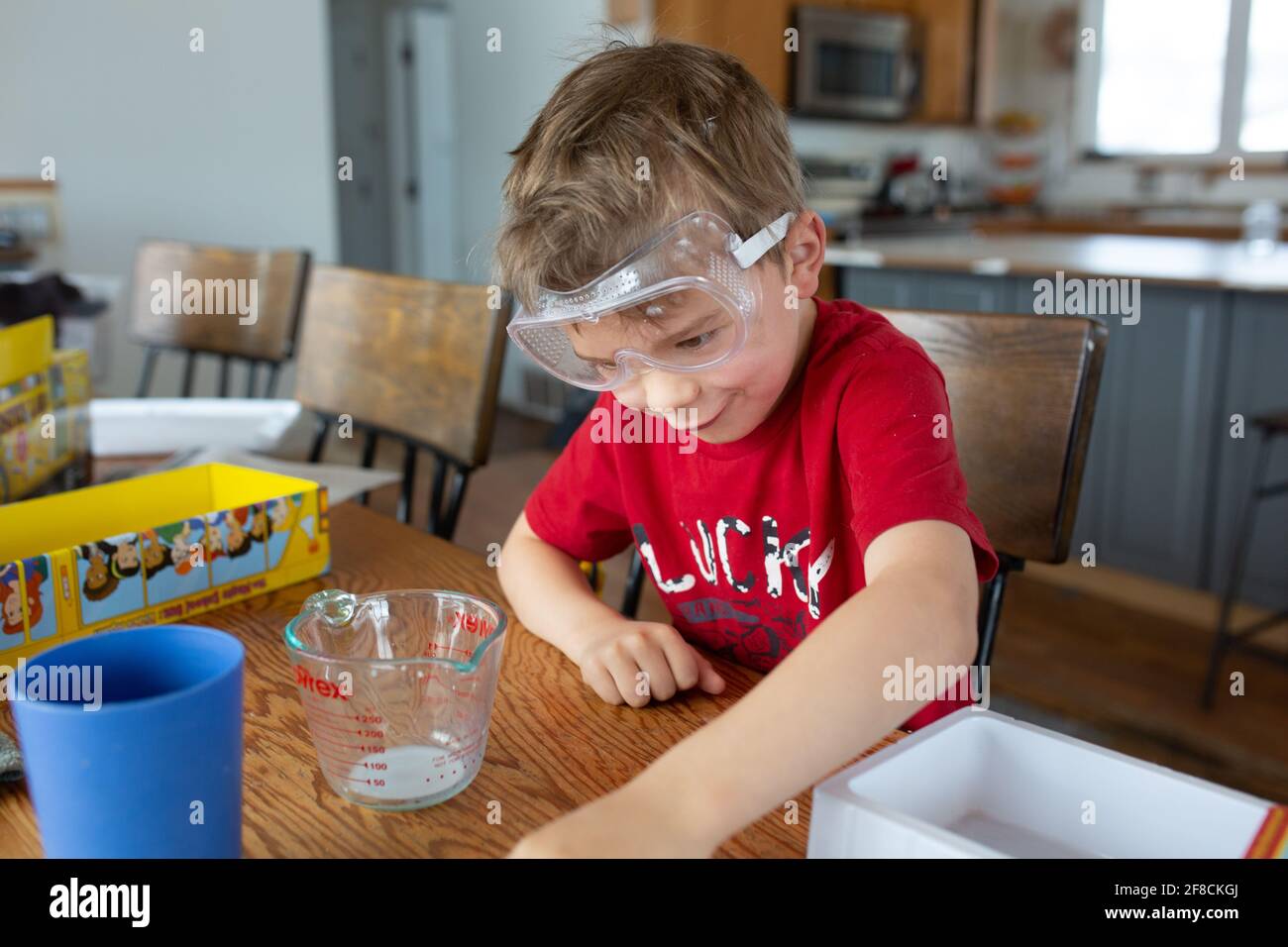 Child making funny face while conducting science experiment Stock Photo