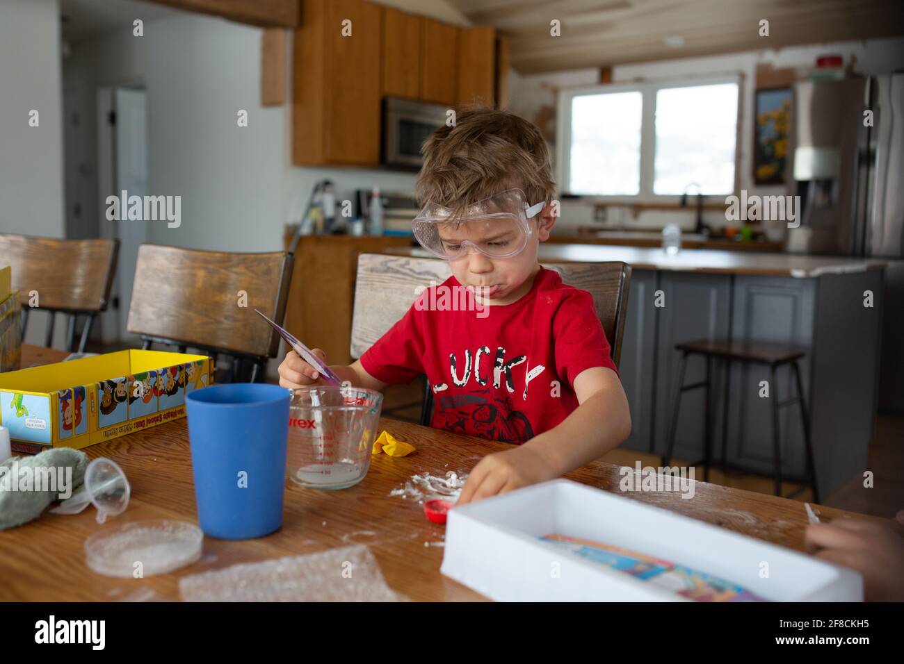 Boy pouting over science experiment gone wrong Stock Photo
