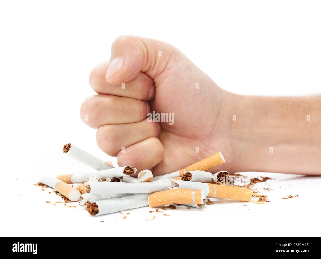 Stop smoking concept fist destroying cigarette packet Stock Photo