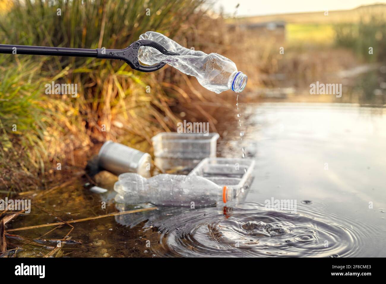 Environmental conservation and pollution collecting garbage and trash from water Stock Photo