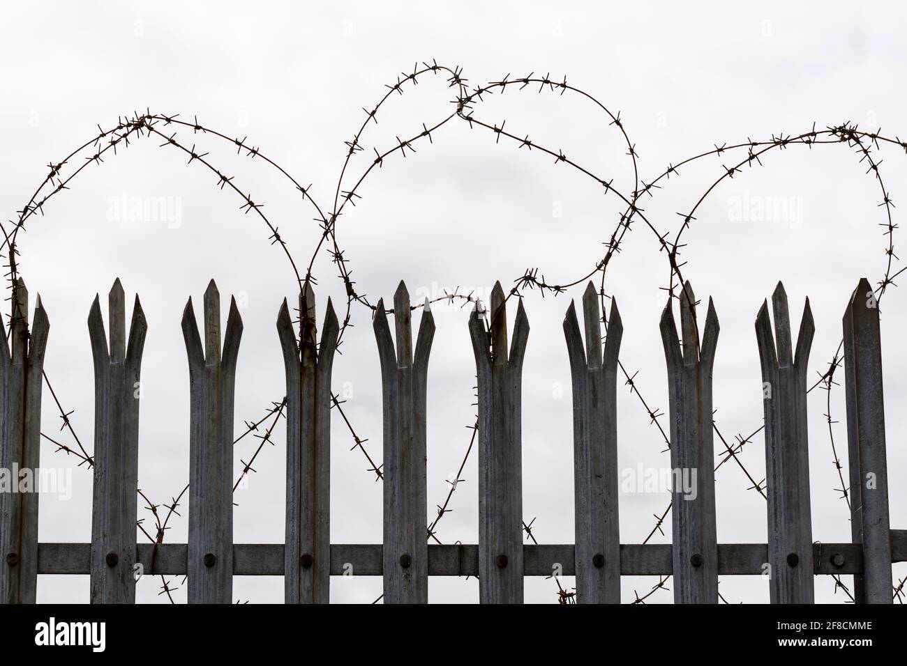 Barbed wire triple point palisade security fence Stock Photo