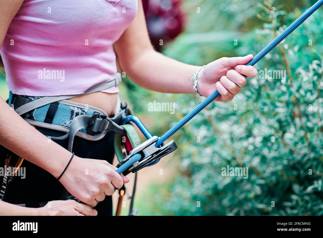 Close-up of a Woman with the climbing and mountaineering harness ...