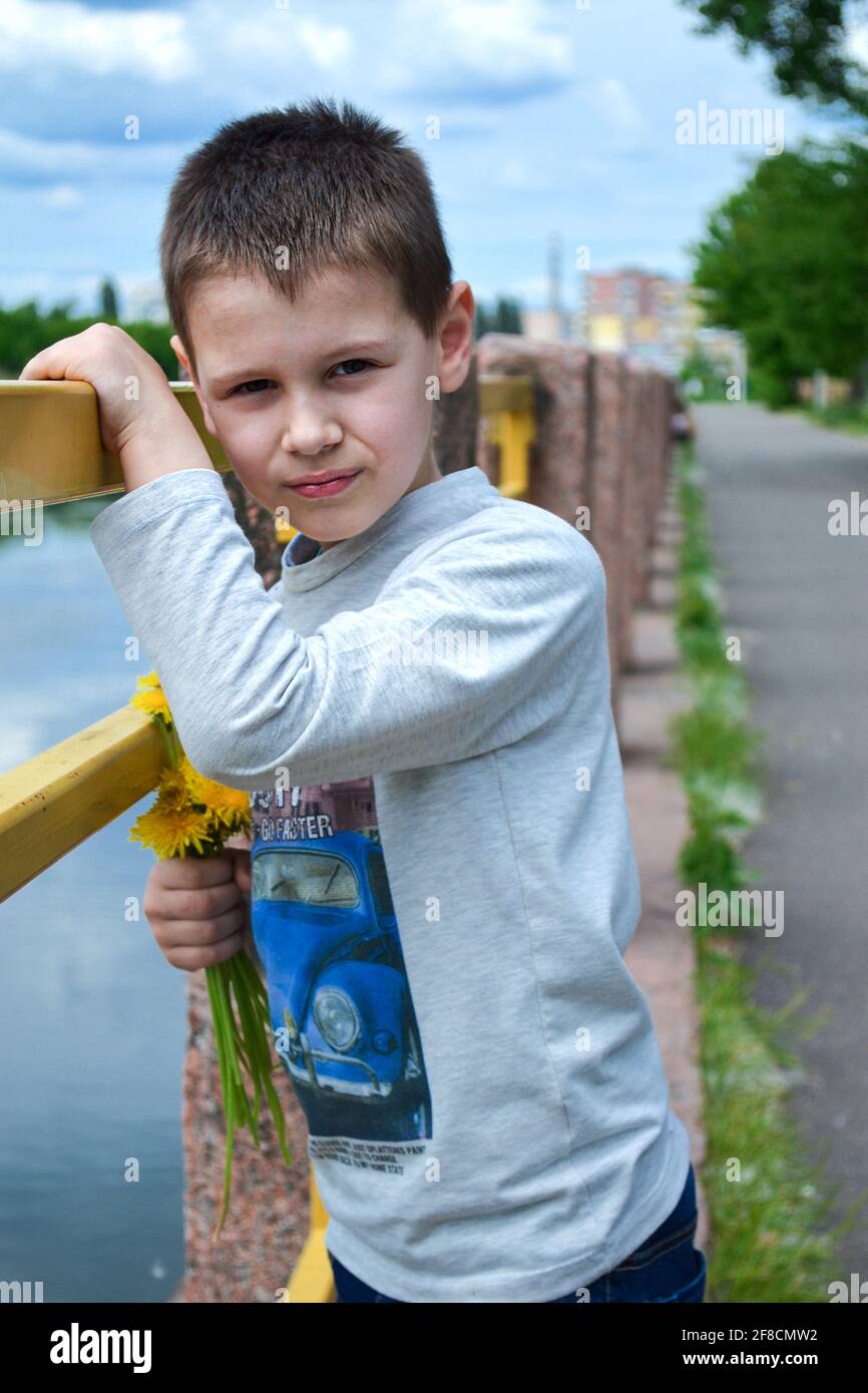 boy standing near the river in park Stock Photo