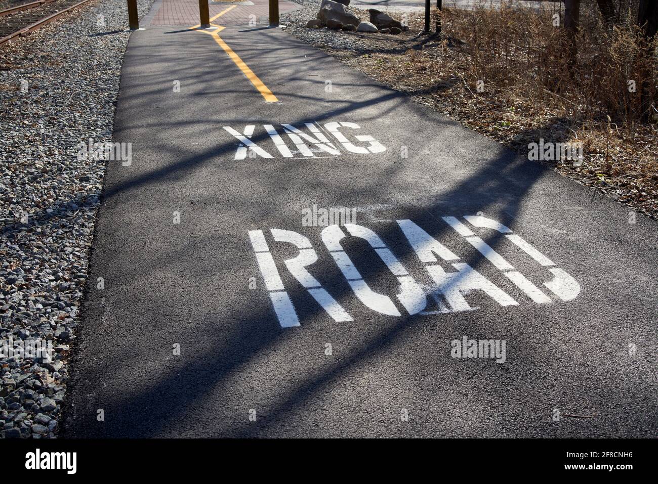 Bike path with road crossing traffic warning on the empire state bike trail in New York State. Stock Photo