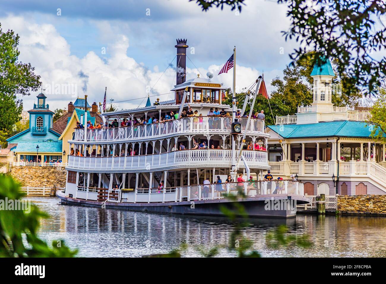Big Steam Boat in Disney World. People are enjoying the great ride though the river within the big park. Lots of kids are having fun and the parents. Stock Photo